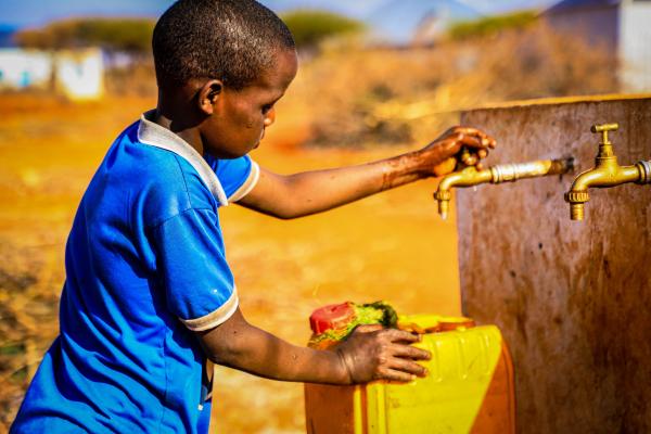 A child fetching water using the borehole recently constructed in Abudwaq