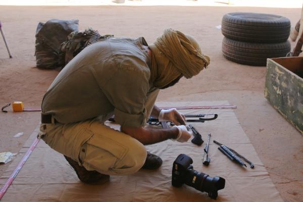CAR field investigator documenting an assault rifle